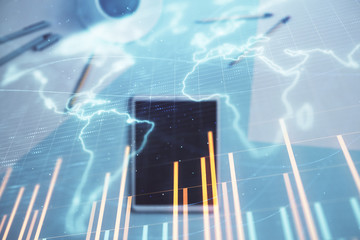 Double exposure of forex chart and world map on digital tablet laying on table background. Concept of market analysis