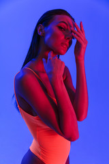 Image of sexual caucasian woman wearing bodysuit underwear posing at camera