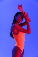 Image of elegant caucasian woman wearing bodysuit underwear posing at camera