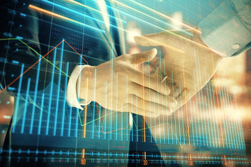 Double exposure of financial chart on cityscape background with two businessmen handshake. Concept of financial analysis and investment opportunities