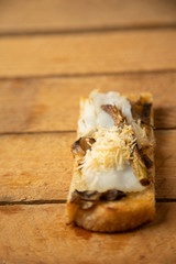 Spanish tapa, bread with cod, green asparagus, mushrooms and cheese