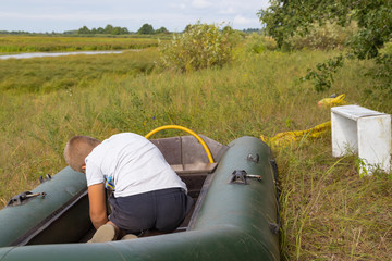 A child is preparing an inflatable boat
