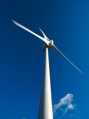 White wind turbine against a blue sky