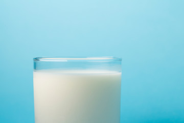  Glass milk on a blue background. source of calcium .Protein rich dairy product. healthy lifestyle concept .