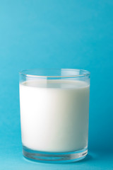  Glass milk on a blue background. source of calcium .Protein rich dairy product. healthy lifestyle concept .