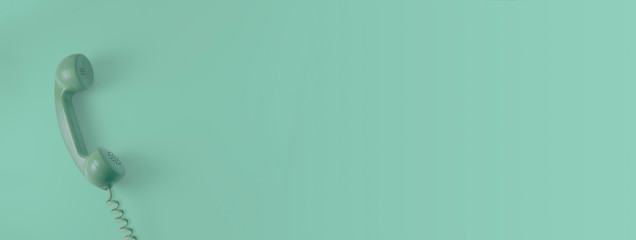 A green vintage dial telephone handset with green background.