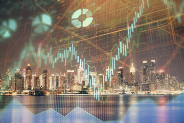 Obraz na płótnie Canvas Financial graph on night city scape with tall buildings background multi exposure. Analysis concept.