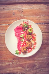 Green Pea Falafel Falafel ball served with tomato salsa and beetroot tahini puree
