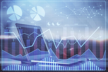 Financial graph colorful drawing and table with computer on background. Multi exposure. Concept of international markets.