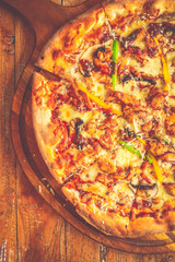 Supreme Pizza Tomato sauce, mozzarella cheese, chicken sausage, bacon, mushroom, red/ green capsicum and black olives