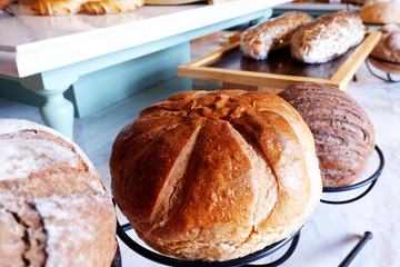 Bread Concept: bun loaf of bread in the wooden bucket on the table displayed in the bakery shop and dining cuisine toasts for breakfast and dinner