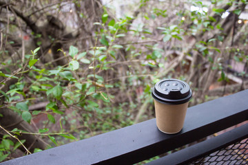 Blur background nature landscape panorama view from top view with brown coffee recycle paper cup. 