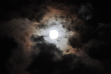 Fototapeta na wymiar Super Full Moon with clouds at Night, Dramatic cumulus clouds in the moonlight