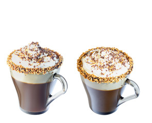 Mug of cappuccino with whipped cream. A mug of chocolate and roasted nuts. Isolate on a white background. The photo.