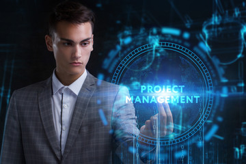 The concept of business, technology, the Internet and the network. A young entrepreneur working on a virtual screen of the future and sees the inscription: Project management