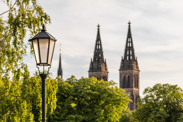 Summer view on city lamp and Vysehrad church, Prague, Czechia