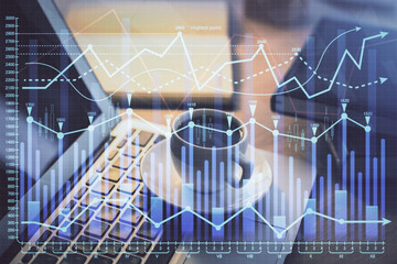 Financial graph colorful drawing and table with computer on background. Double exposure. Concept of international markets.