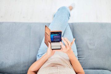 Woman using smart-phone inside the apartment.
