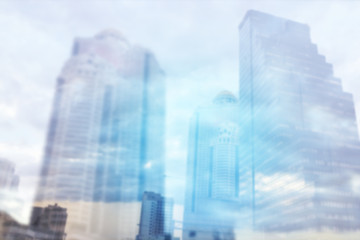 Abstract Blurred background, Double exposure of business Skyscraper with sunrise and sky clouds, business and finance background concept