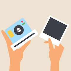 Blue camera for snapshots in hand. The other hand holds a snapshot. Snapshot frame. Photo card appears. Lens. Gadget for photos. Flat style. Editable vector illustration