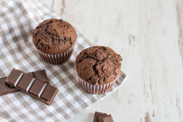 Just baked chocolate muffins with chocolate pieces.