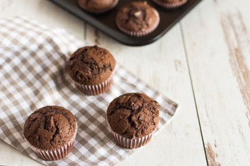 Just baked chocolate muffins with chocolate pieces.