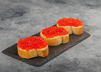 sandwich with red caviar on the table