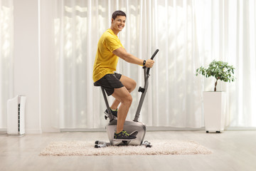 Young man exercising on a stationary bike