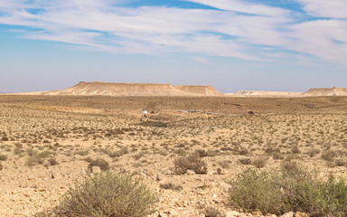 view from highway 40 in israel overlooking the upper ein avdat parking lot in the negev highlands with the nahal zin cliffs in the background