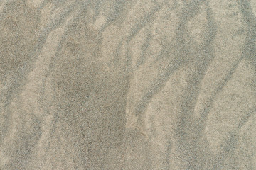 Natural sandy beach background with wavy texture