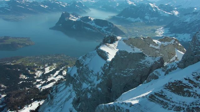 Mountain Pilatus and Lake Lucerne in Sunny Winter Morning. Swiss Alps, Switzerland. Aerial View. Drone Flies Forward, Tilt Up. Reveal Shot