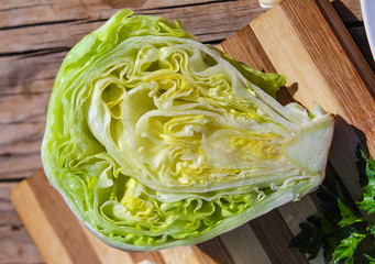 fresh green Iceberg lettuce on a cutting board 