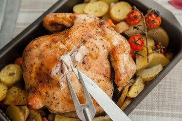 roast chicken and potato slices for thanksgiving day holiday, close up.