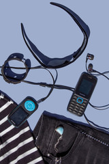 Objects related to leisure time and lifestyle - dark glasses, a cell phone, mp3 player and clothes ready for use