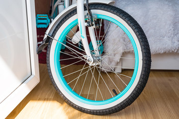 Bicycle wheel with metal spokes and turquoise rim