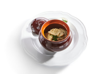 Traditional Polish Dumplings in a clay Ceramic Pot