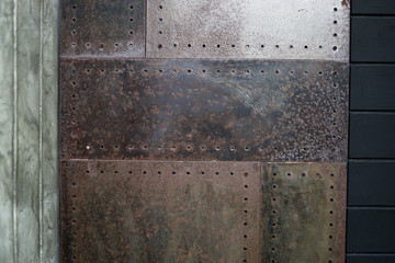 Closeup Polished plaster walls Gouging the rusty iron door and dark stained wood.
