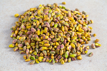 pistachio nuts on granite surface