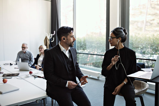 Businesswomen talking with colleagues in conference room