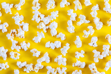 Popcorn on yellow background. Popcorn pattern. Flat lay, top view, copy space