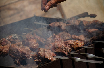 Cooking kebab. Chunks of meat on skewers on the grill