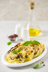 Spicy roasted cabbage steaks. Selective focus, copy space.