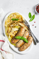 Grilled cabbage steaks with smoked sausages.Top view, copy space.