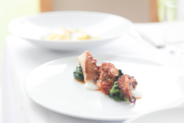 Close up on a dish with gourmet octopus salad