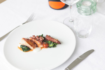 Close up on a dish with gourmet octopus salad