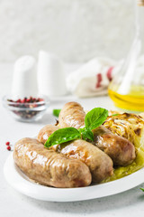 Garlic roasted cabbage steaks with spicy sausages. Selective focus, copy space.