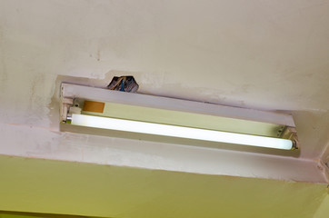 Old neon ceiling lamp with its electric installation