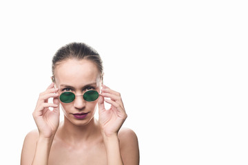 Fototapeta premium Fashion girl model in green sunglasses isolated on white background looking at the camera. Studio shot.