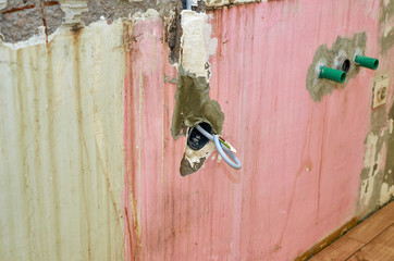 New electric installation in a wall for a socket outlet during reconstruction works in an apartment