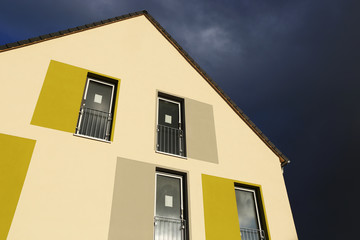 Modern apartment building with green and gray facade painting